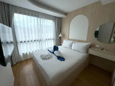 a hotel room with a bed with towels on it at New 2br apartment -stylish Fantasea Kamala Condo in Kamala Beach
