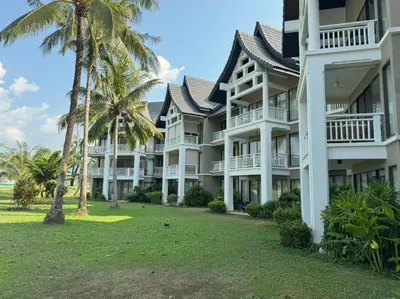 an exterior view of a resort with palm trees at Private apartment at Allamanda II by Lofty in Bang Tao Beach