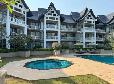 an apartment building with a swimming pool in front of it at Private apartment at Allamanda II by Lofty in Bang Tao Beach