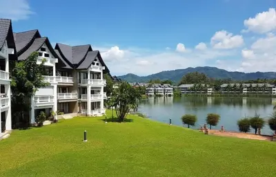 a row of apartment buildings next to a lake at Private apartment at Allamanda II by Lofty in Bang Tao Beach