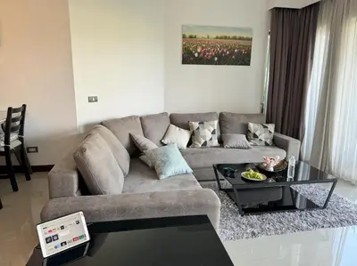 a living room with a couch and a coffee table at Private apartment at Allamanda II by Lofty in Bang Tao Beach