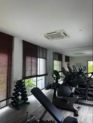 a gym with several treadmills and elliptical machines at Luxury Villa in heart of Bang Tao! Villa BEAM in Laguna Phuket