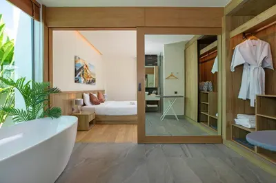 a bathroom with a tub and a bedroom at Luxury Villa in heart of Bang Tao! Villa BEAM in Laguna Phuket