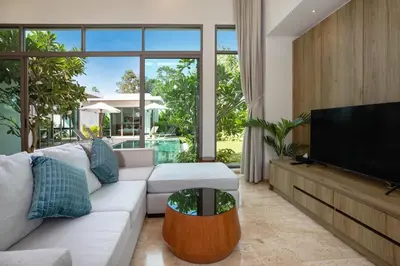 a living room with a white couch and a flat screen tv at Luxury Villa in heart of Bang Tao! Villa BEAM in Laguna Phuket