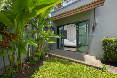 a garden view of a house with a sliding glass door at VILLA Hanga 3BR Private Pool Nai Harn Beach in Nai Harn Beach