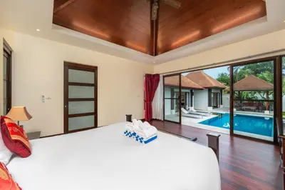 a bedroom with a large bed and a pool at Villa Iorangi 3 Bedroom Private Pool in Rawai Beach
