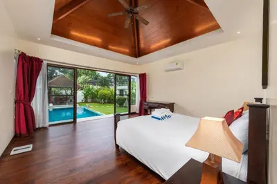 a bedroom with a bed and a ceiling fan at Villa Iorangi 3 Bedroom Private Pool in Rawai Beach