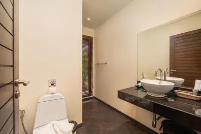 a bathroom with a toilet and a sink and a mirror at Villa Iorangi 3 Bedroom Private Pool in Rawai Beach
