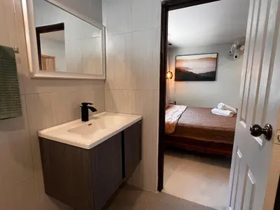 a bathroom with a sink and a bed at Newly Renovated Sea View House in Karon Beach