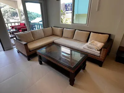 a living room with a couch and a coffee table at Newly Renovated Sea View House in Karon Beach