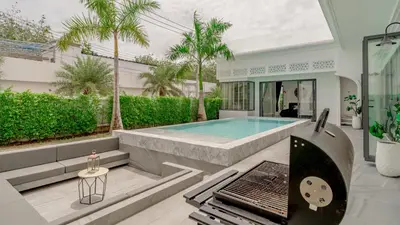 a swimming pool in the middle of a house at Bang Tao Luxury Villa - Menara Hill in Ban Phak Chit