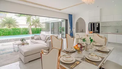 a dining room and living room with a table and chairs at Bang Tao Luxury Villa - Menara Hill in Ban Phak Chit