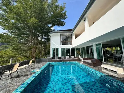 a swimming pool in the backyard of a house at Ananda Place in Ban Pa Khlok