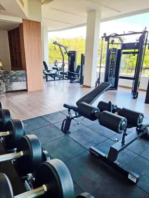 a gym with several rows of treadmills and machines at The City Condo Near Central Fest Phuket, Pool view in Ban Sam Kong