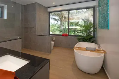a bathroom with a large tub and a window at villa Lahaina in Rawai Beach