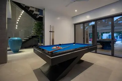 a room with a pool table in a house at villa Lahaina in Rawai Beach