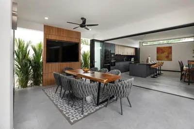 a dining room and kitchen with a table and chairs at Stunning 4 bedrooms pool villa at Rawai kokmakham 2 in Rawai Beach