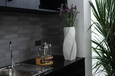 a vase of flowers on a counter next to a sink at Stunning 4 bedrooms pool villa at Rawai kokmakham 2 in Rawai Beach