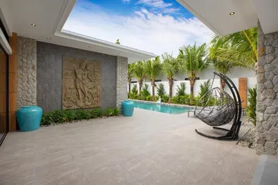 a courtyard with a swimming pool and palm trees at Stunning 4 bedrooms pool villa at Rawai kokmakham 2 in Rawai Beach