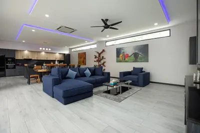a living room with blue couches and a table at Stunning 4 bedrooms pool villa at Rawai kokmakham 2 in Rawai Beach