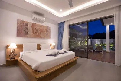 a bedroom with a large bed and a large window at Two-Bedroom Villa with Salt Pool in Rawai villa hapai in Rawai Beach