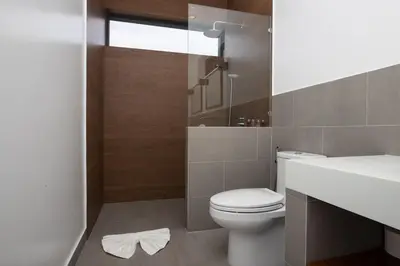 a bathroom with a white toilet and a sink at Two-Bedroom Villa with Salt Pool in Rawai villa hapai in Rawai Beach