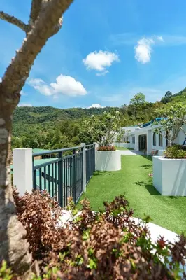 a view of the yard of a house at Stylish 1 bdr Kamala beach Roof Pool Gym free wifi in Kathu