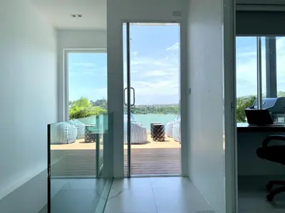 an open door to a balcony with a view of the ocean at Seaview Duplex Home - Panwa Beach - Baan Jayden in Phuket Town