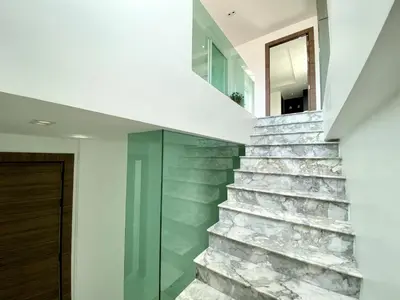 a stone staircase in a house with a glass door at Seaview Duplex Home - Panwa Beach - Baan Jayden in Phuket Town