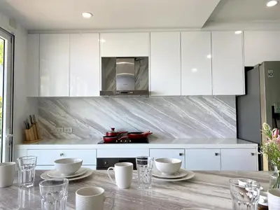 a kitchen with white cabinets and a table with cups at Seaview Duplex Home - Panwa Beach - Baan Jayden in Phuket Town