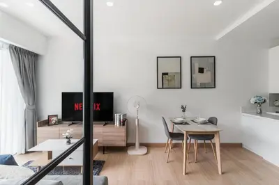 a white apartment with a dining room and a table at Karon Beach Hill View Appartment in Karon Beach