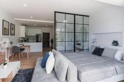 a large bedroom with a large bed and a kitchen at Karon Beach Hill View Appartment in Karon Beach