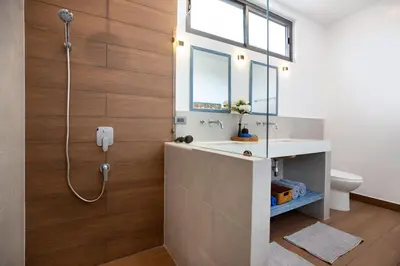 a bathroom with a shower and a sink and a toilet at Sumptuous 4 bedroom pool villa at rawai beach RB 2 in Rawai Beach