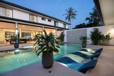 a villa with a swimming pool and a house at Sumptuous 4 bedroom pool villa at rawai beach RB 2 in Rawai Beach