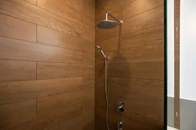a bathroom with a shower with wooden walls at Sumptuous 4 bedroom pool villa at rawai beach RB 2 in Rawai Beach