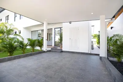 an empty courtyard of a house with palm trees at Sumptuous 4 bedroom pool villa at rawai beach RB 2 in Rawai Beach