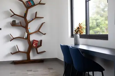 a room with a table and chairs and a tree at Sumptuous 4 bedroom pool villa at rawai beach RB 2 in Rawai Beach