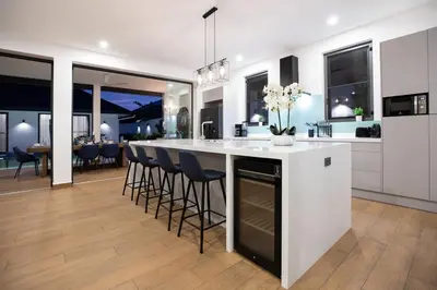 a kitchen with a large white island with bar stools at Sumptuous 4 bedroom pool villa at rawai beach RB 2 in Rawai Beach