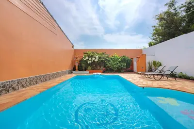 a swimming pool in the backyard of a house at Family Holiday 3BR Pool Villa Lancelot 2 in Rawai Beach