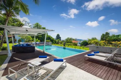 an image of a swimming pool with chairs and an umbrella at Spectacular Ocean Views 8BR Pool Villa Sawan in Patong! Relax & Play - Billiard, Table football, Gym & Sauna! in Patong Beach