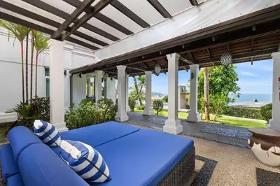 a blue couch on a porch with a view of the ocean at Spectacular Ocean Views 8BR Pool Villa Sawan in Patong! Relax & Play - Billiard, Table football, Gym & Sauna! in Patong Beach