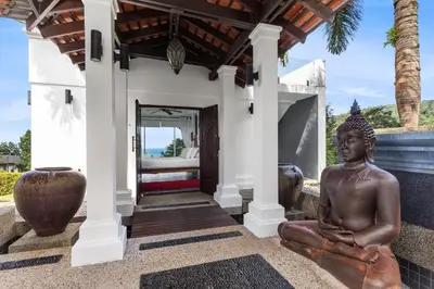 a statue sitting on the front porch of a house at Spectacular Ocean Views 8BR Pool Villa Sawan in Patong! Relax & Play - Billiard, Table football, Gym & Sauna! in Patong Beach