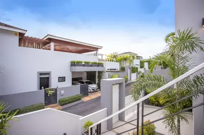 an aerial view of a white house with palm trees at Private 4BR Pool Villa Skylight with Stunning Views of Kamala Green Hills in Kamala Beach