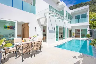 an exterior view of a house with a swimming pool at Private 4BR Pool Villa Skylight with Stunning Views of Kamala Green Hills in Kamala Beach