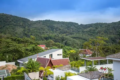 a view of houses and mountains with trees at Private 4BR Pool Villa Skylight with Stunning Views of Kamala Green Hills in Kamala Beach