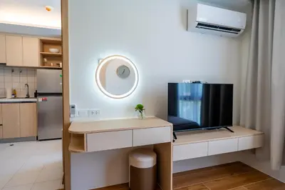 a living room with a tv and a table with a tv at Dream 1 BdR Kamala Beach Free Parking WiFi Gym in Kathu