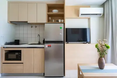 a kitchen with a refrigerator and a table at Dream 1 BdR Kamala Beach Free Parking WiFi Gym in Kathu