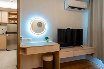 a living room with a tv on a desk with a television at Dream 1 BdR Kamala Beach Free Parking WiFi Gym in Kathu