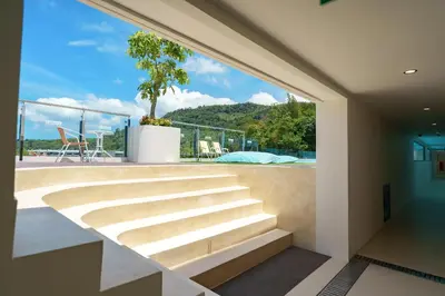 a view from the balcony of a house with stairs at Dream 1 BdR Kamala Beach Free Parking WiFi Gym in Kathu