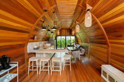a kitchen and dining room in a log cabin with wooden walls at New 3BR Chalet-Style Villa Pasak Paradise 3, Private Pool, 10min drive to Laguna Phuket in Bang Tao Beach